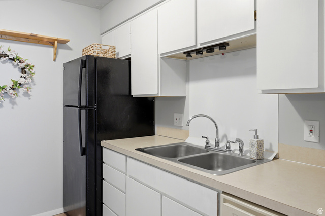 1175 Canyon Road, Unit 86 Ogden, UT 84404 - Photo 13 of 29 Kitchen area featuring white cabinetry, light-toned countertops, and a dual-basin stainless steel sink with a chrome faucet