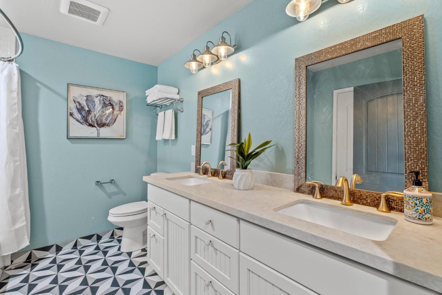 12 Crescent Drive Scotts Valley, CA 95066 - Photo 28 of 61 a bathroom with a sink a toilet a mirror and vanity