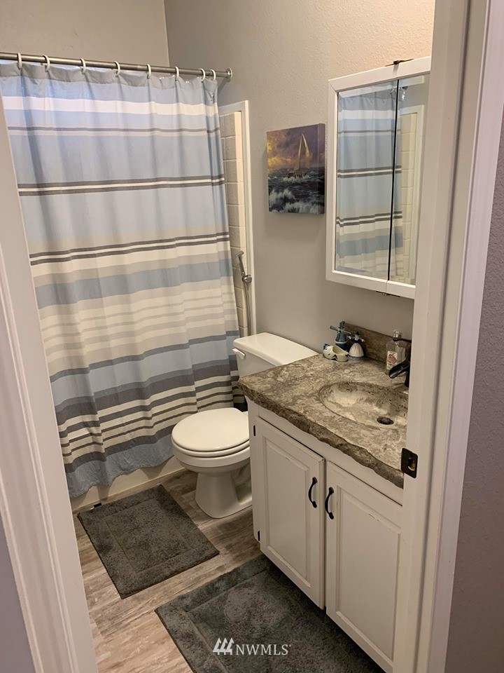1769 Pangborn Road Lynden, WA 98264 - Photo 25 of 37 a bathroom with a granite countertop sink toilet and shower