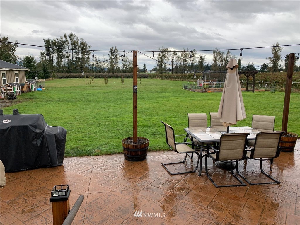 1769 Pangborn Road Lynden, WA 98264 - Photo 29 of 37 a view of a chairs and table in patio next to a yard