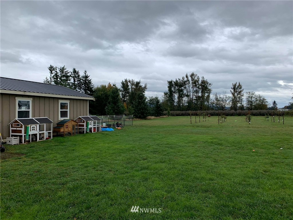 1769 Pangborn Road Lynden, WA 98264 - Photo 33 of 37 a view of a house with backyard sitting area and garden