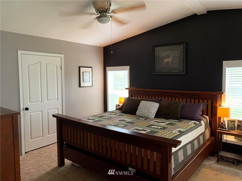 1769 Pangborn Road Lynden, WA 98264 - Photo 8 of 37 a bedroom with a bed and a chandelier