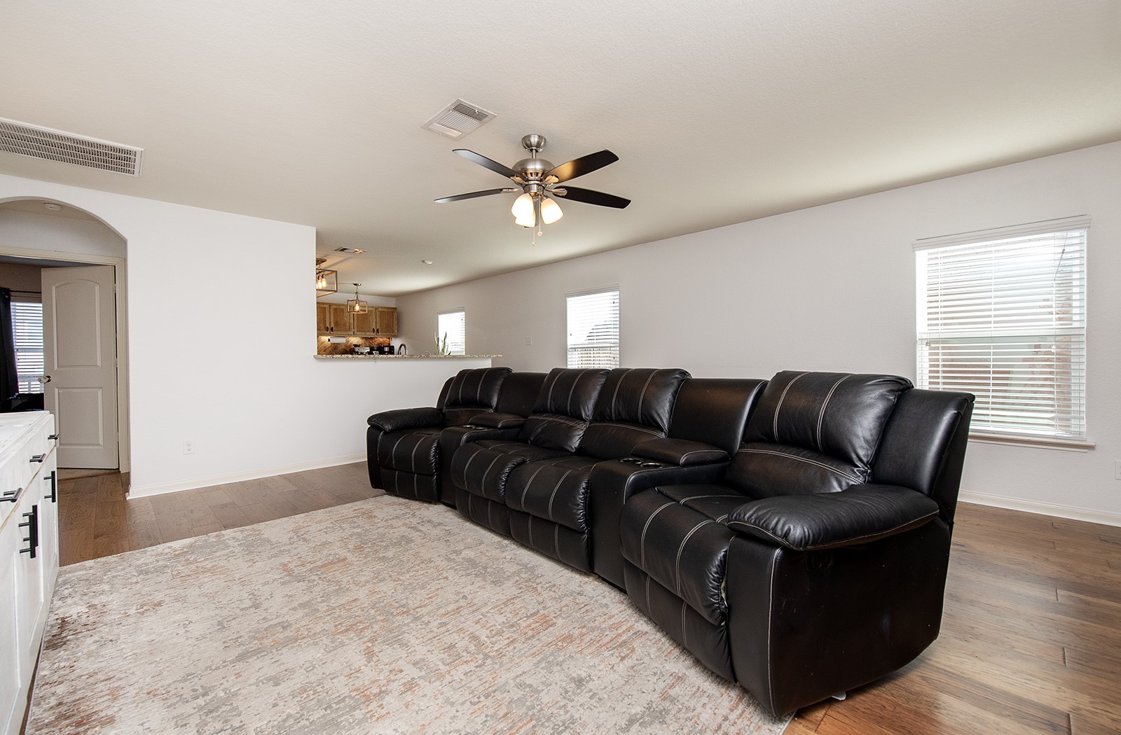 216 Millers Loop Jarrell, TX 76537 - Photo 7 of 31 Living room with arched walkways, hard wood flooring, and a ceiling fan