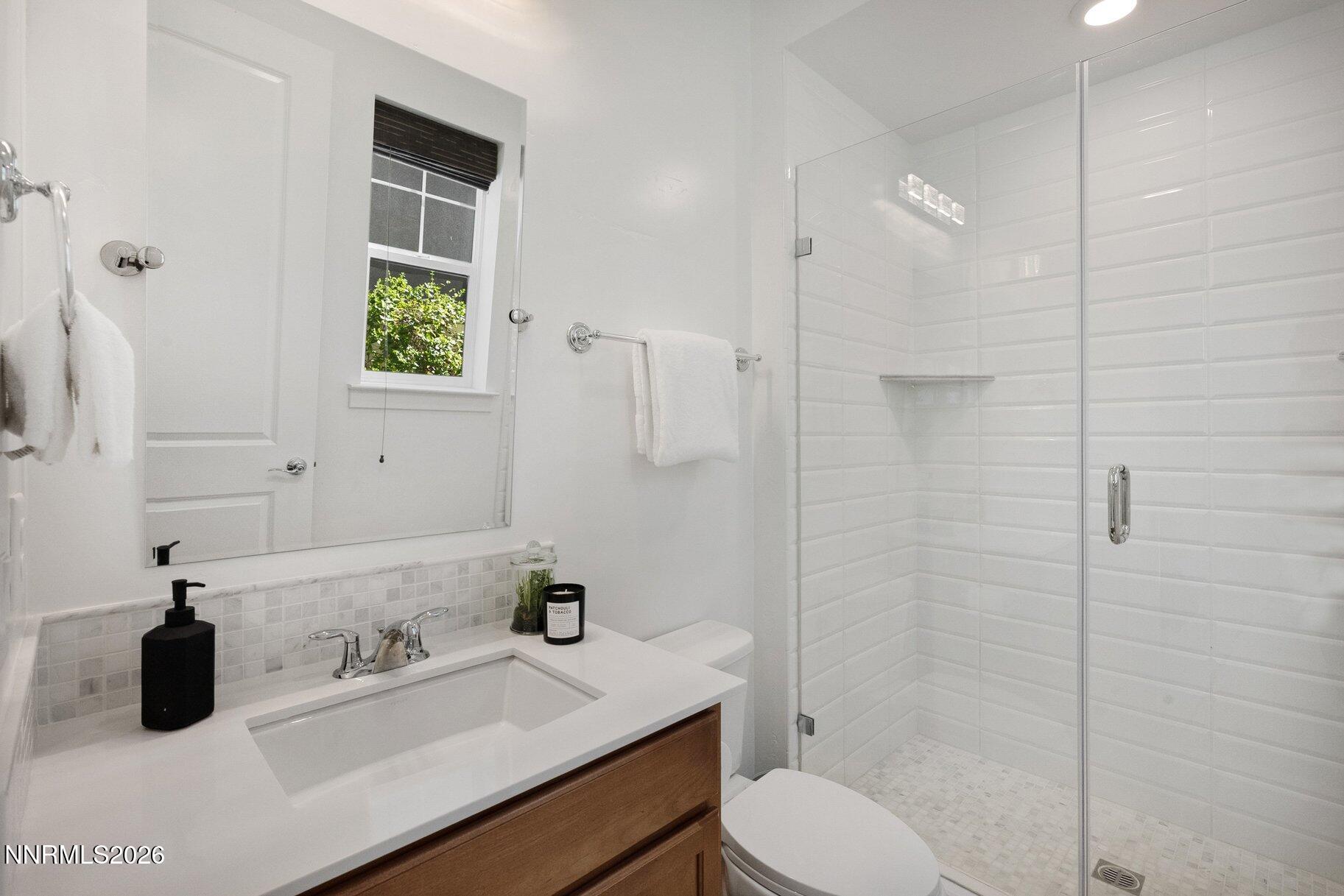 6110 South Pleasant Oak Trail Reno, NV 89511 - Photo 28 of 66 a bathroom with a sink toilet and shower
