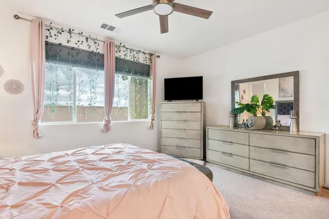 a bedroom with a bed and a flat screen television