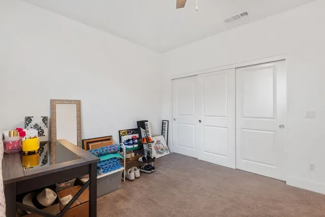 a view of room with toys and a ceiling fan