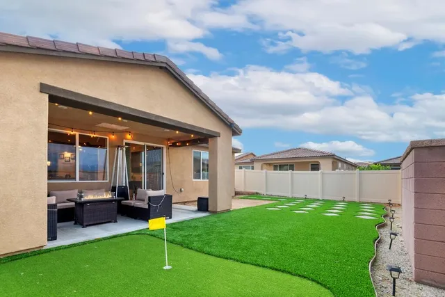 a view of a house with a backyard