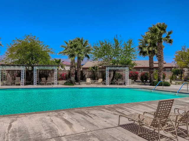 a view of a patio with table and chairs potted plants with floor to ceiling windows