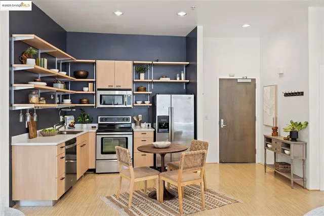 a kitchen with stainless steel appliances granite countertop a refrigerator and a stove top oven