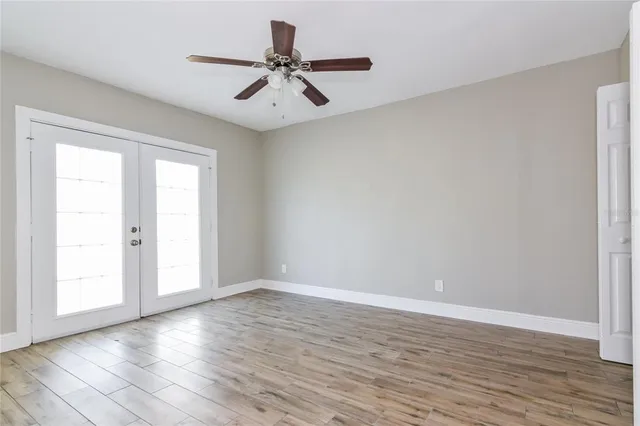 a view of a room with wooden floor and natural light