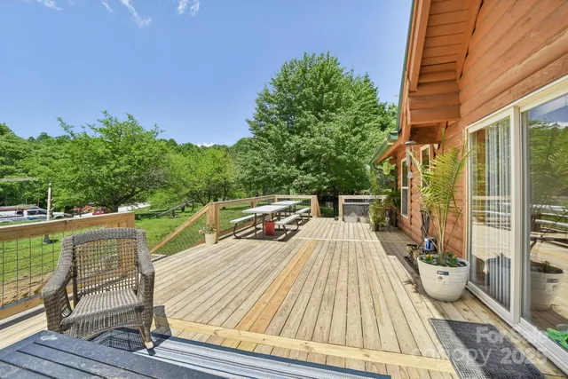 a view of balcony with wooden floor and seating space