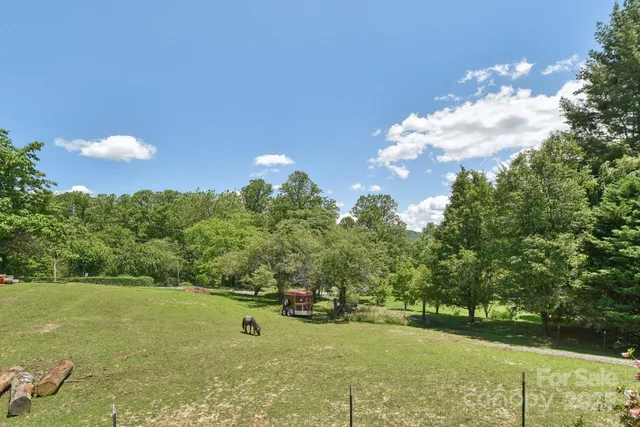 a view of a house with a yard and sitting area