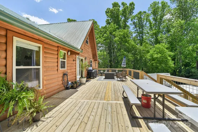 a front view of a house with a garden and trees