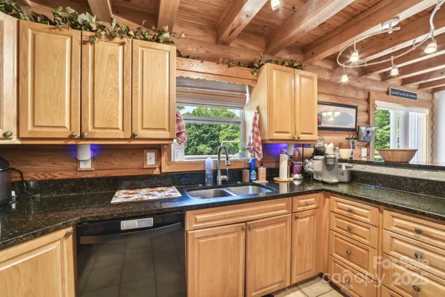 a kitchen with sink a window and cabinets