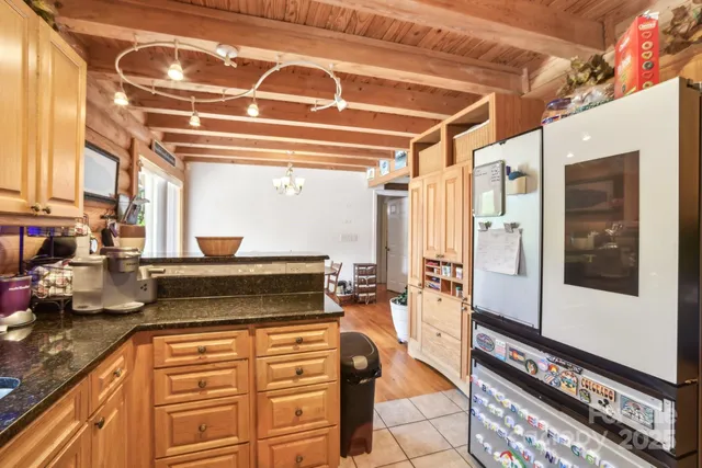 a kitchen with stainless steel appliances granite countertop a stove and a refrigerator