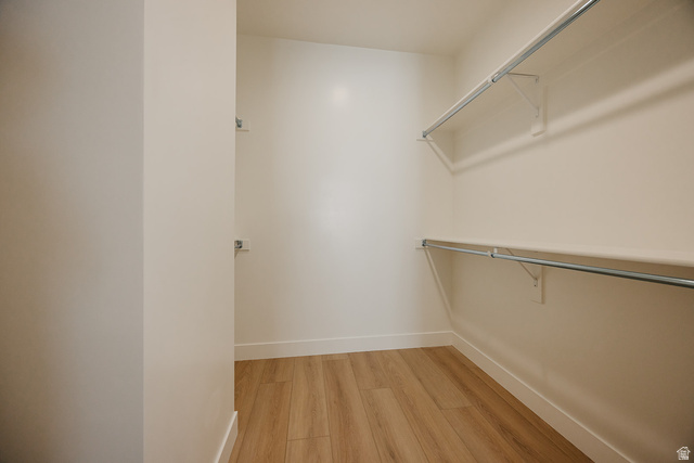 5910 Canyon Rim Road, Unit 619 Lehi, UT 84048 - Photo 28 of 52 Walk-in closet with wood-finish flooring, white walls, and built-in shelving