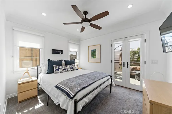 a living room with furniture a ceiling fan and a window