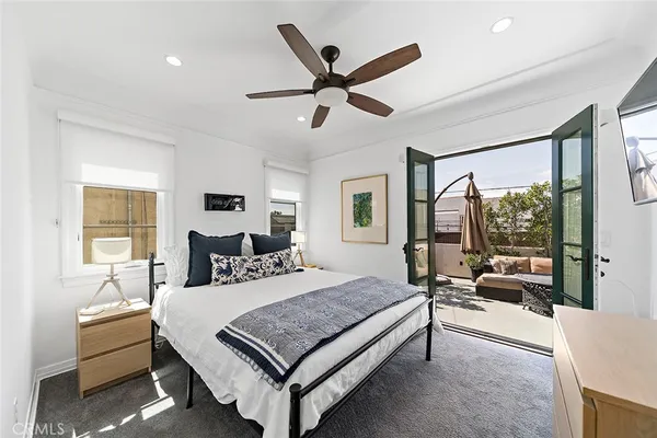 a bedroom with a bed couch and window