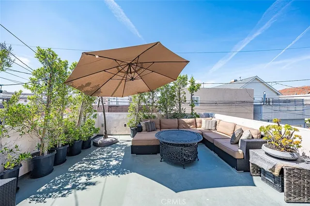 a patio with patio a table and chairs under an umbrella