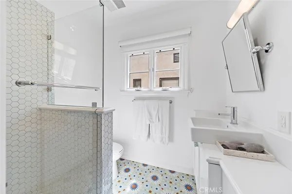 a bathroom with a bathtub sink vanity and mirror