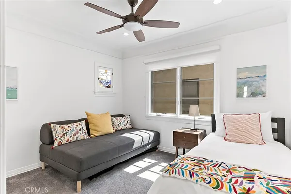 a bedroom with two beds and a large window