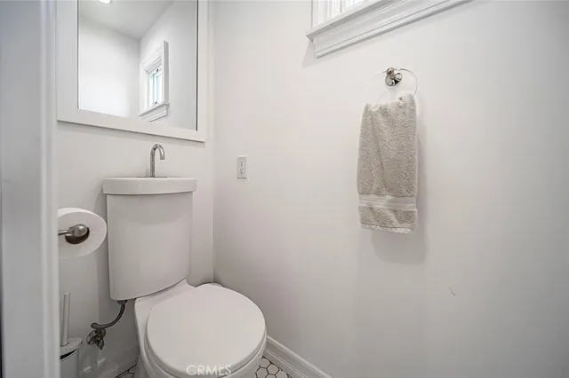 a white toilet sitting next to a bathroom sink