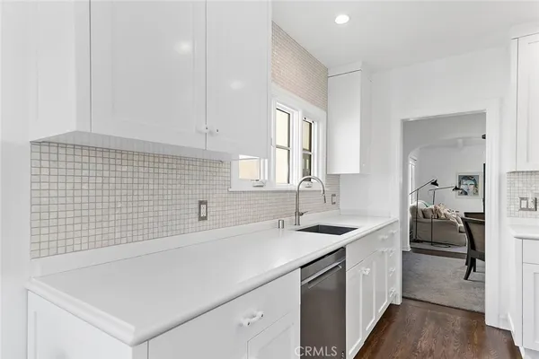 a kitchen with a sink and a stove top oven