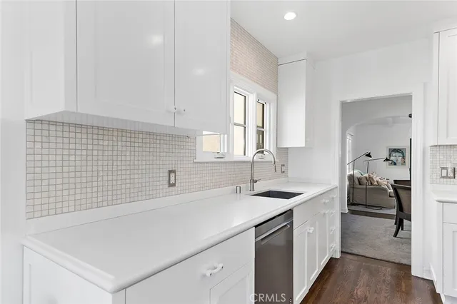 a kitchen with a sink and a stove top oven