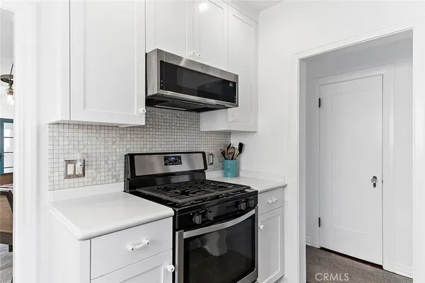 a kitchen with a stove and a microwave