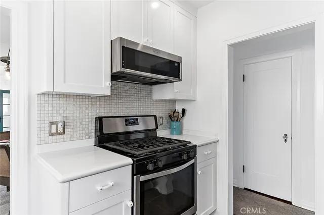 a kitchen with a stove and a microwave