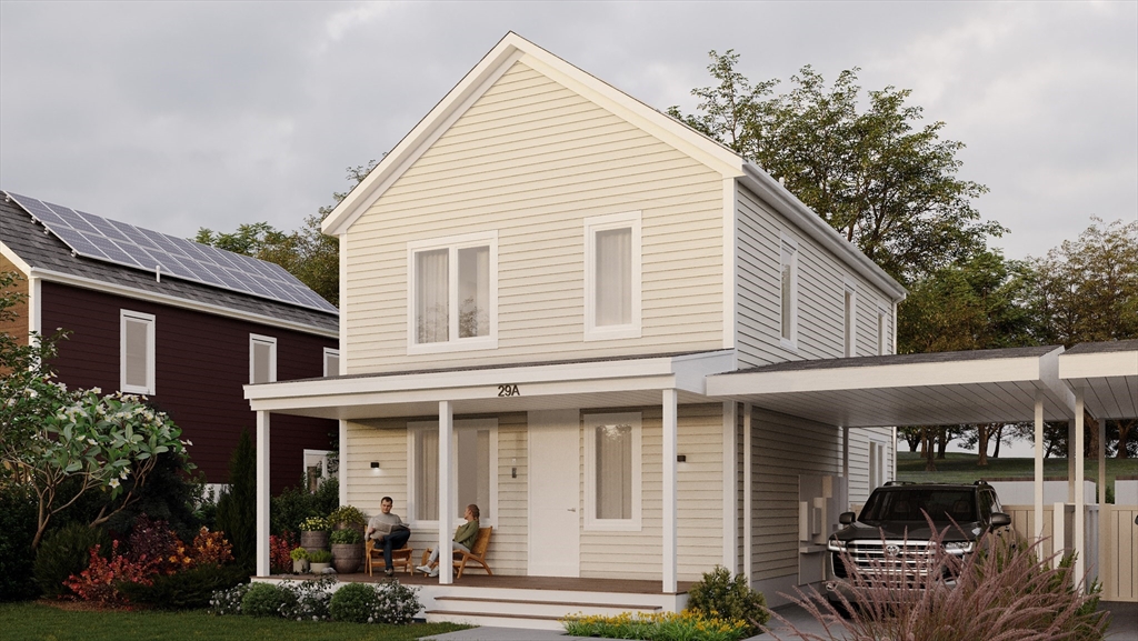 a view of a white house next to a yard