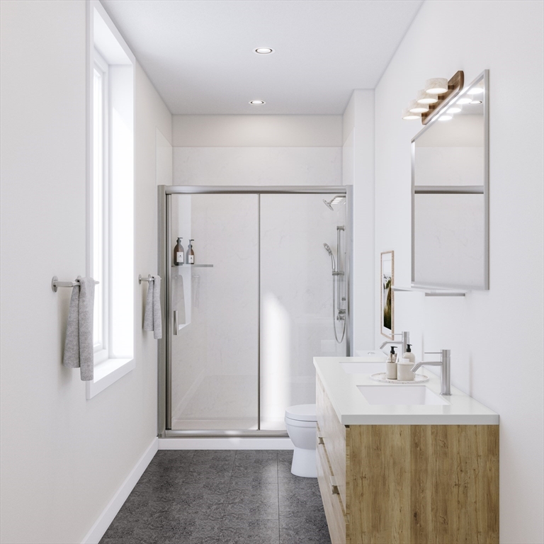 25 Adams Circle, Unit A Devens, MA 01434 - Photo 11 of 22 a bathroom with a sink a mirror and a shower