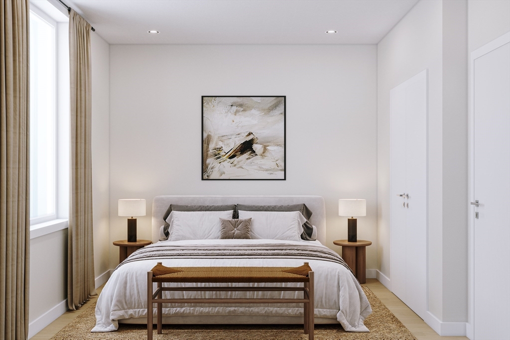 25 Adams Circle, Unit A Devens, MA 01434 - Photo 14 of 22 a bedroom with a bed and a painting on the wall