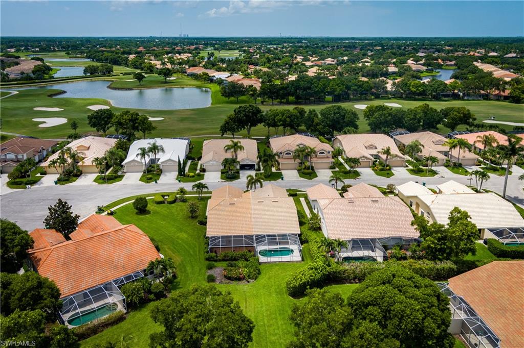 6658 Castlelawn Place, Unit 9 Naples, FL 34113 - Photo 35 of 38 Aerial perspective showcasing a residential community with numerous homes featuring screened pools