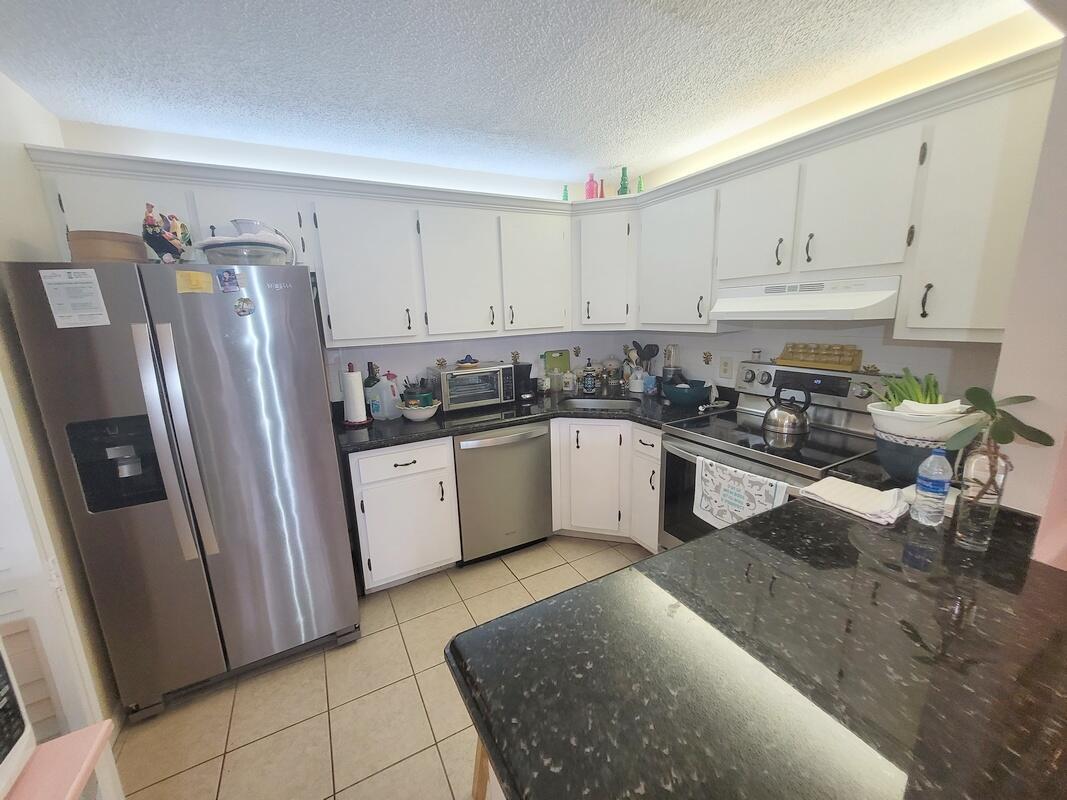 320 Pine Ridge Circle, Unit A1 Greenacres, FL 33463 - Photo 18 of 65 a kitchen with a sink stainless steel appliances and cabinets