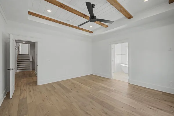 a view of an empty room and wooden floor