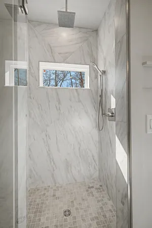a bathroom with a toilet sink and shower