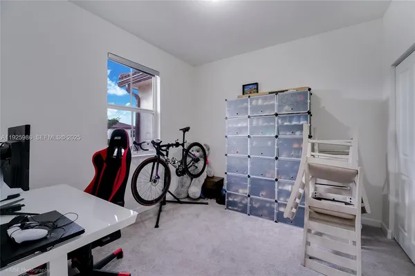 a view of room with guitars and wooden floor