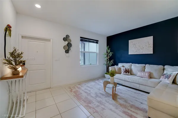 a living room with furniture and a potted plant