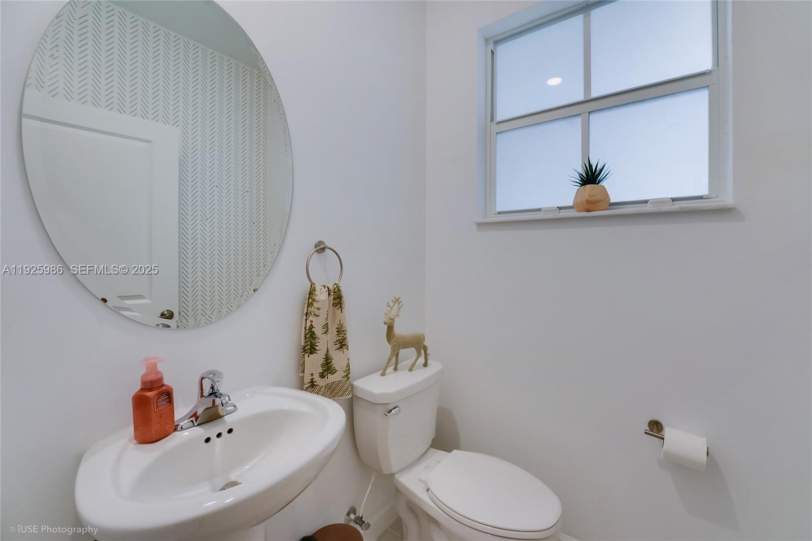 12453 Northwest 23rd Court Miami, FL 33167 - Photo 8 of 15 a bathroom with a sink mirror and toilet