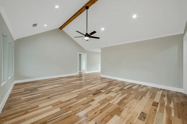 a view of a livingroom with a ceiling fan and wooden floor
