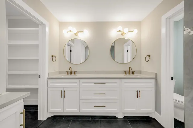 a bathroom with a double vanity sink and a mirror