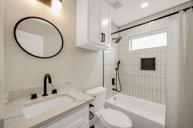 a bathroom with a sink a toilet and a mirror