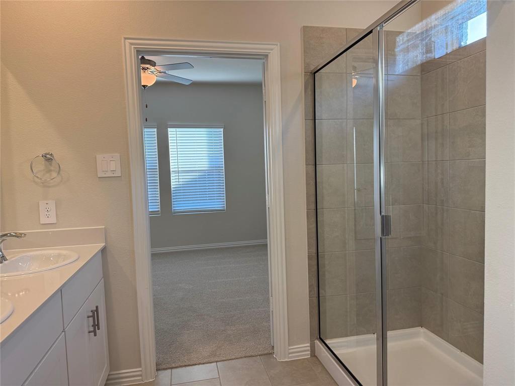 1736 Arches Road Anna, TX 75409 - Photo 9 of 15 Walk-in shower with clear glass enclosure and light-toned tile surround