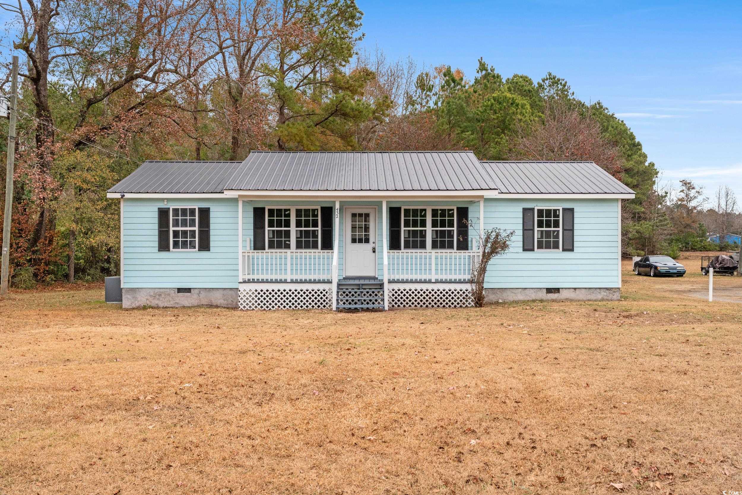 View of front of home with crawl space, a porch, and a front yard