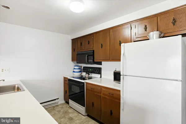 a kitchen with stainless steel appliances a refrigerator stove microwave and sink