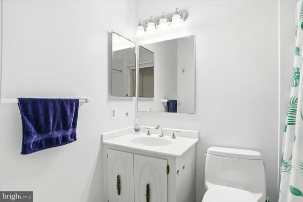 a bathroom with a sink vanity and mirror