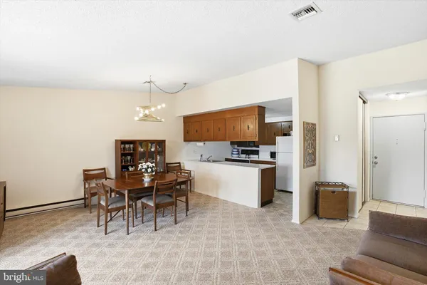 a living room with furniture and kitchen view
