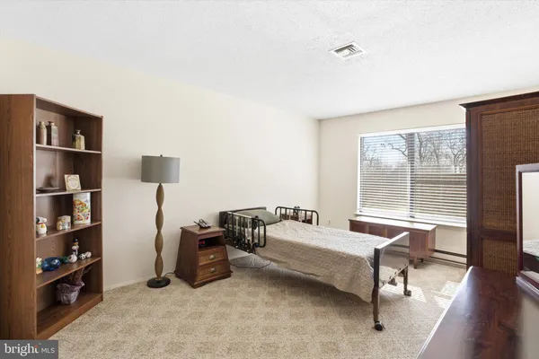 a living room with furniture a rug and a large window