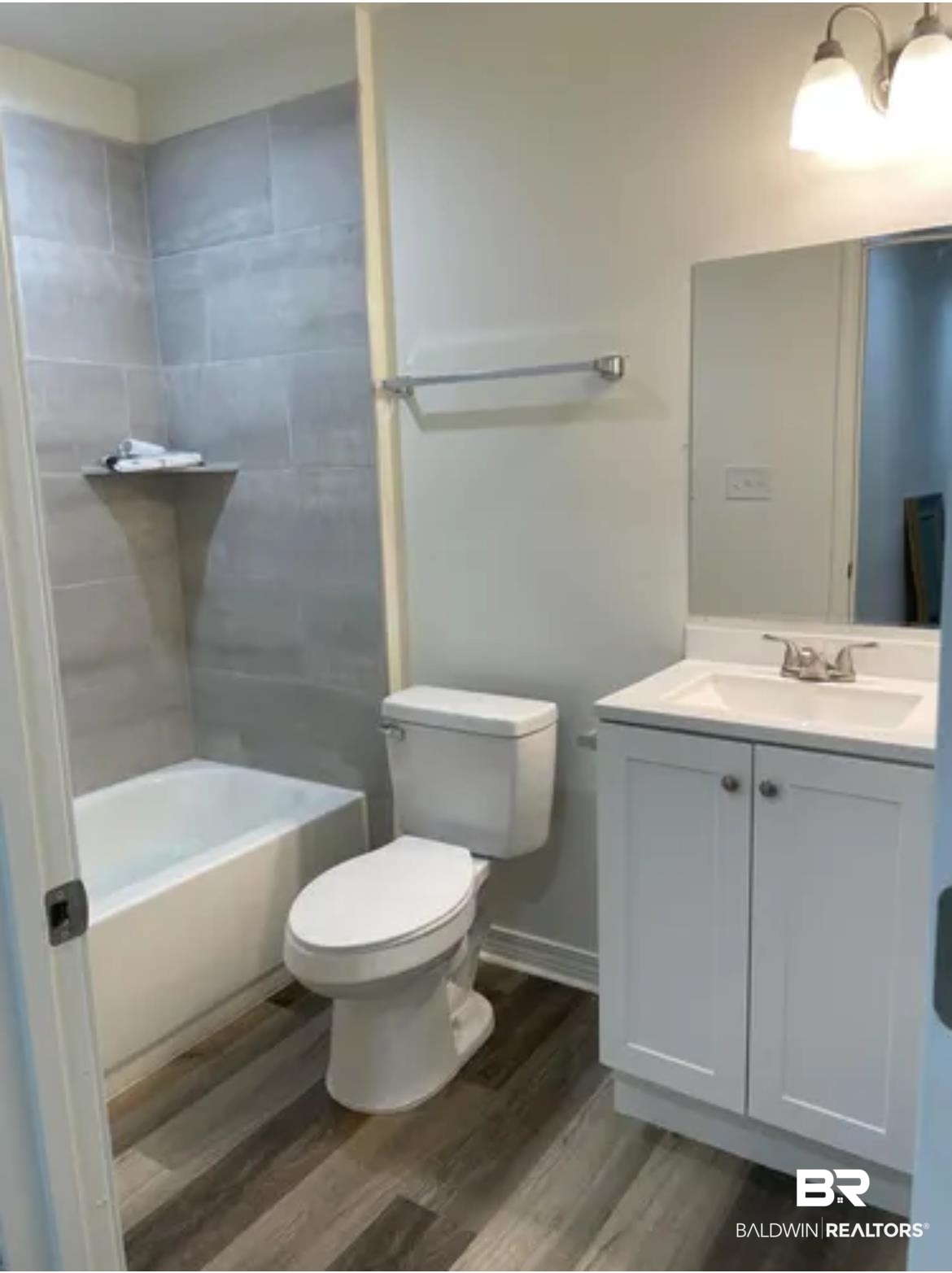 2 Canterberry Circle Foley, AL 36535 - Photo 23 of 24 Full bathroom with toilet, vanity, wood finished floors, shower combination, and baseboards